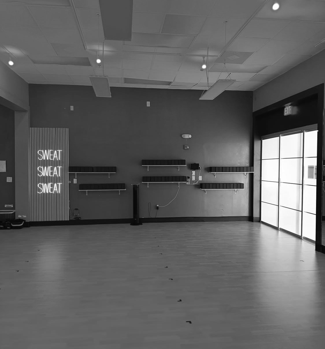 Fire Flow studio interior with SWEAT neon sign and infrared lighting
